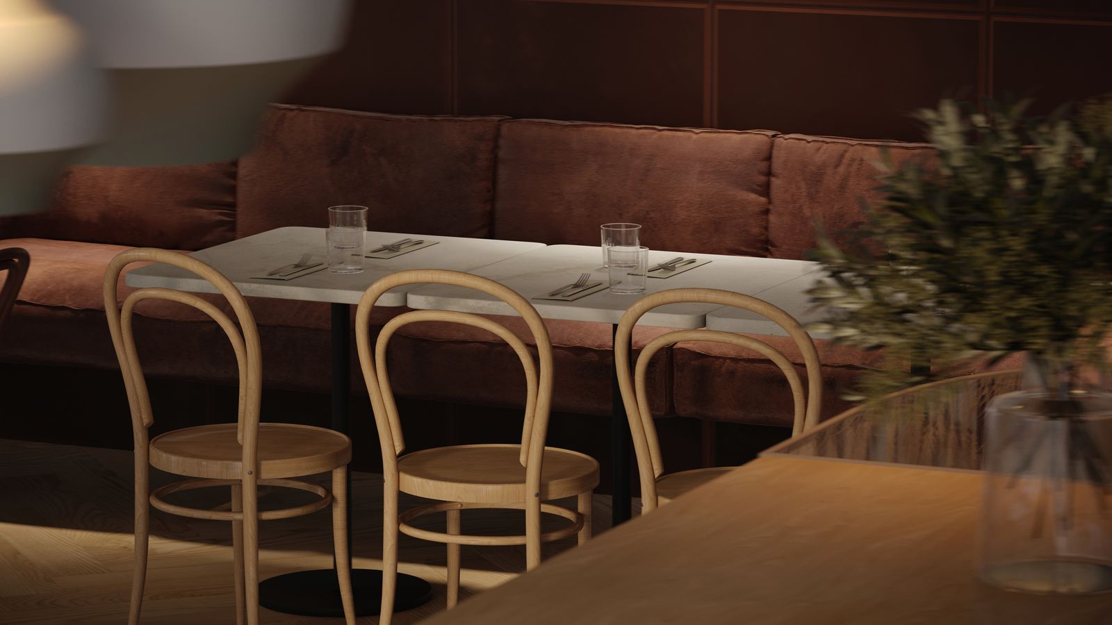 Table set between the banquette and the bentwood chairs