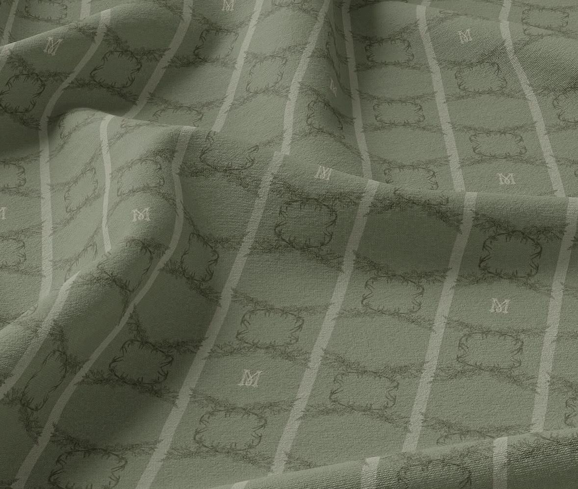The green Vila Muhr pattern woven into cloth, monogram in the repeat