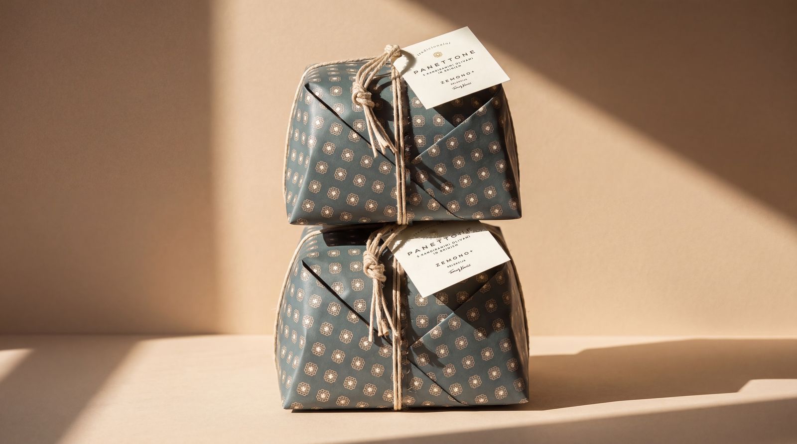 Two wrapped panettoni stacked in low winter sun